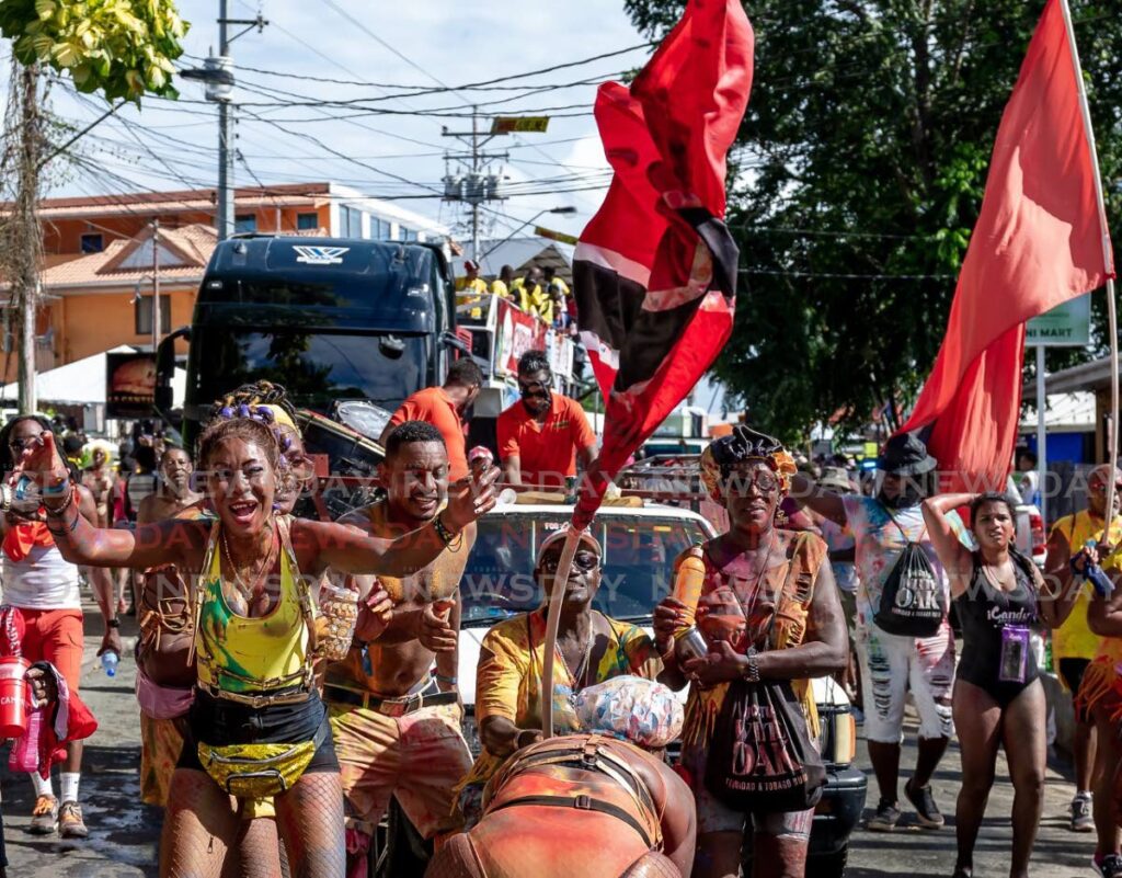 Masqueraders make merry in the streets from Bon Accord to Crown Point for J'Ouvert in Tobago on Saturday. - David Reid