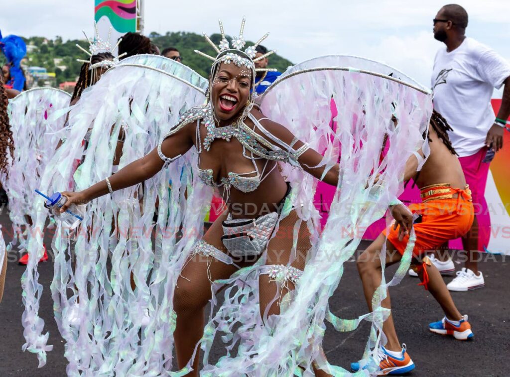 A masquerader from Zain Carnival Band plays her mas during the Tobago carnival parade of the bands, on the Rockly Bay carnival stage on Milford Road, Scarborough, Sunday. Photo by David Reid