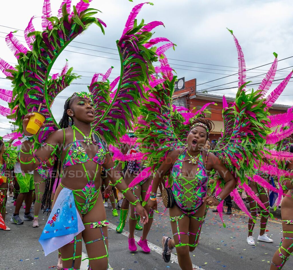 Masqueraders from Jade Monkey carnival band's tustee section on the road during the parade of the bands on Sunday, along Milford Road, Scarborough, Tobago. Photo by David Reid
