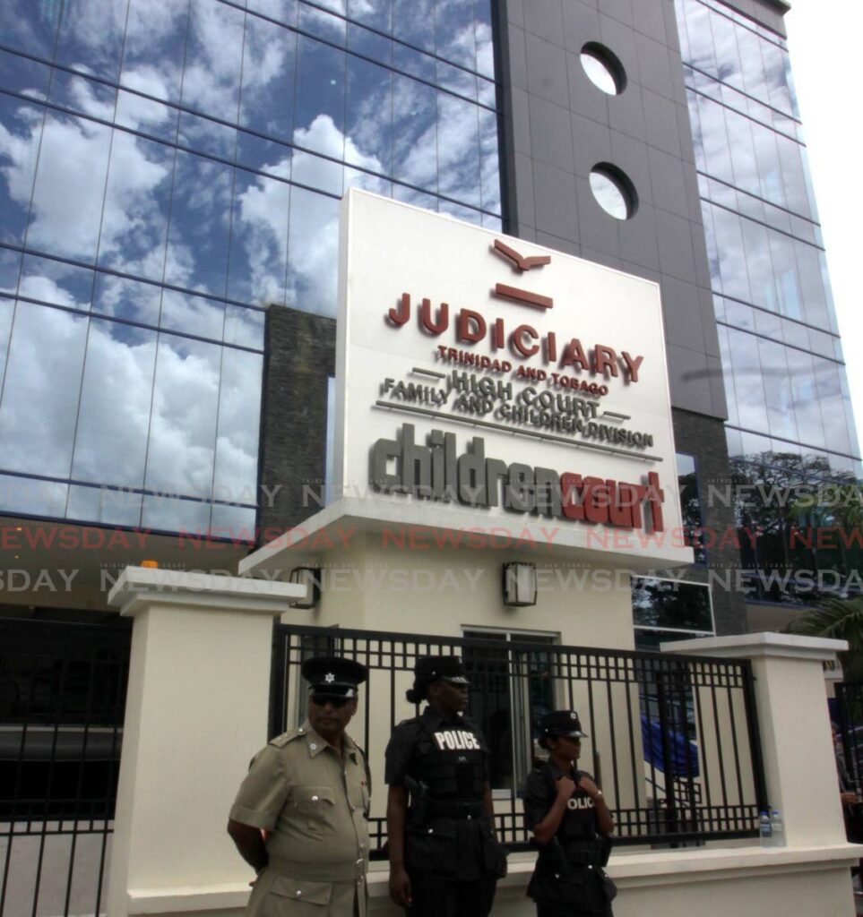 In this file photo, police officers stand guard outside the Children Court on Elizabeth Street, St Clair, during its formal opening in March 2018. - ROGER JACOB