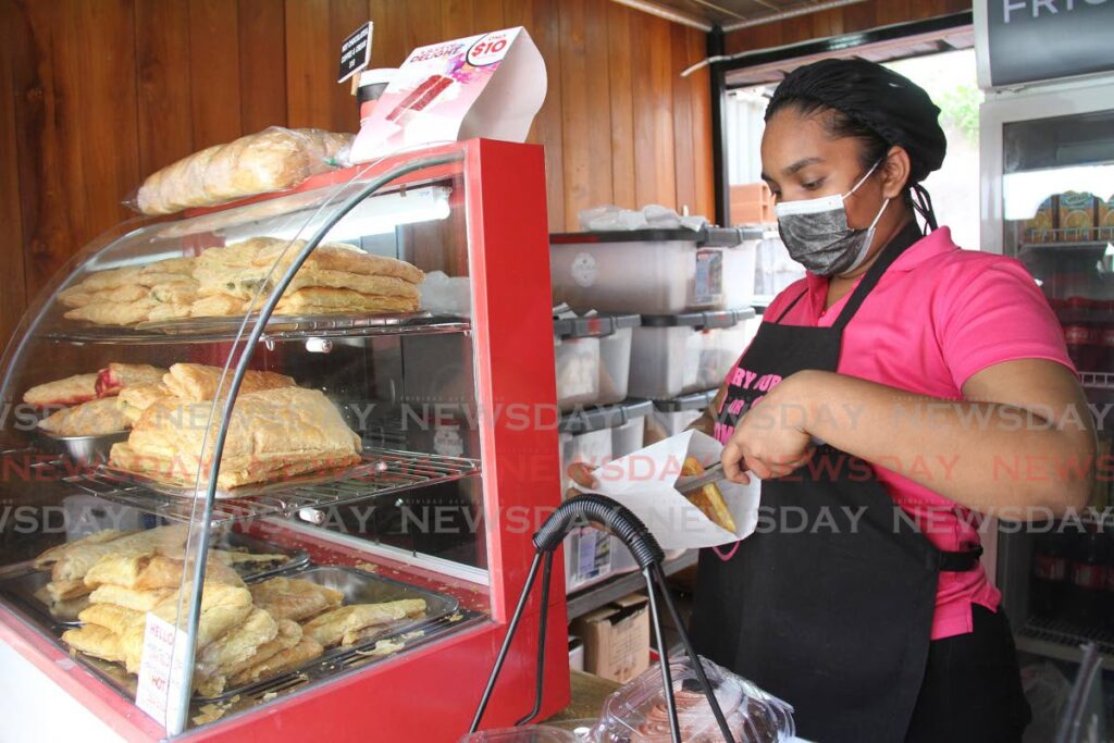 Cafe Bean employee Sarah Bajan bags pastry at its location, corner of Chaguanas and Southern main roads in Chaguanas in this July 19, 2021 photo.  - FILE PHOTO/ANGELO MARCELLE