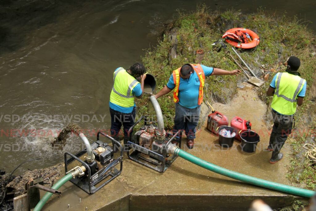In this August 2021 file photo, WASA workers do maintenance work at the North Oropouche water treatment plant, off Valencia Road, Valencia. - AYANNA KINSALE