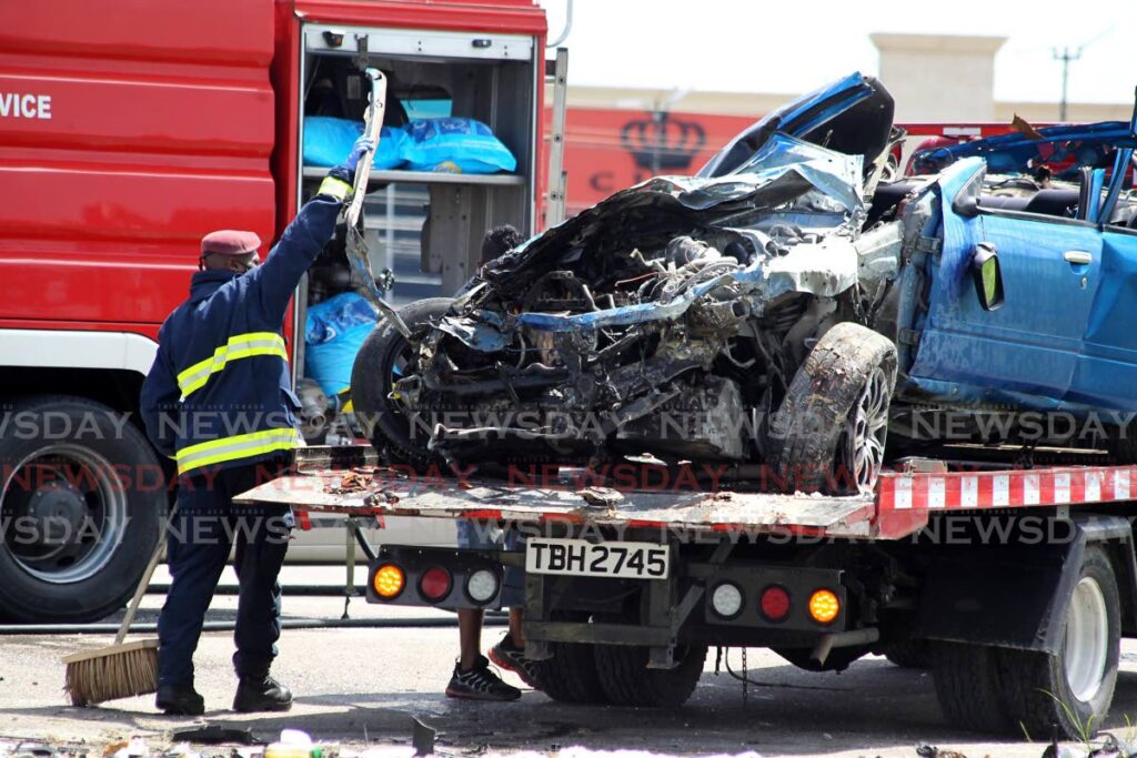 A fire officer uses a lift to place a Nissan Primera sedan on a wrecker after a fatal accident oon the Uriah Butler Highway, Chaguanas on October 31, 2021. - FILE PHOTO/ROGER JACOB