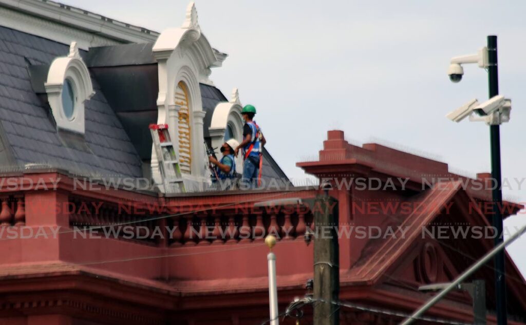 In this file photo, workers carry out repairs on the roof of the Red House in January. - Photo by Sureash Cholai