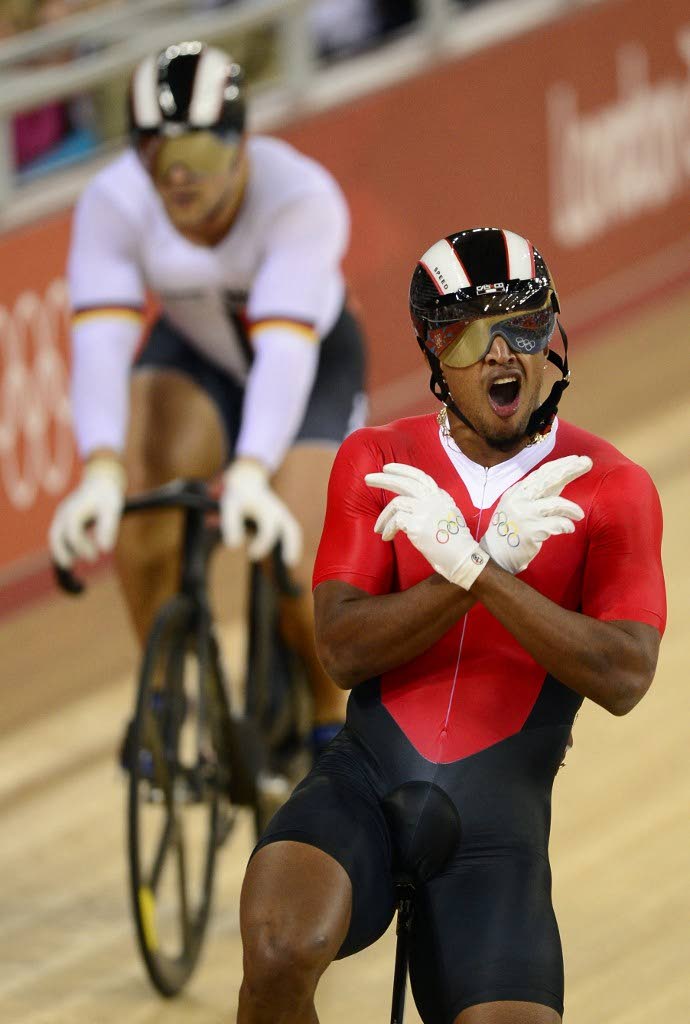 In this August 4, 2012 file photo, TT's Njisane Phillip celebrates after winning against Robert Forstemann of Germany during the London 2012 Olympic Games men's sprint round of eight cycling event at the Velodrome in the Olympic Park in East London.  - 