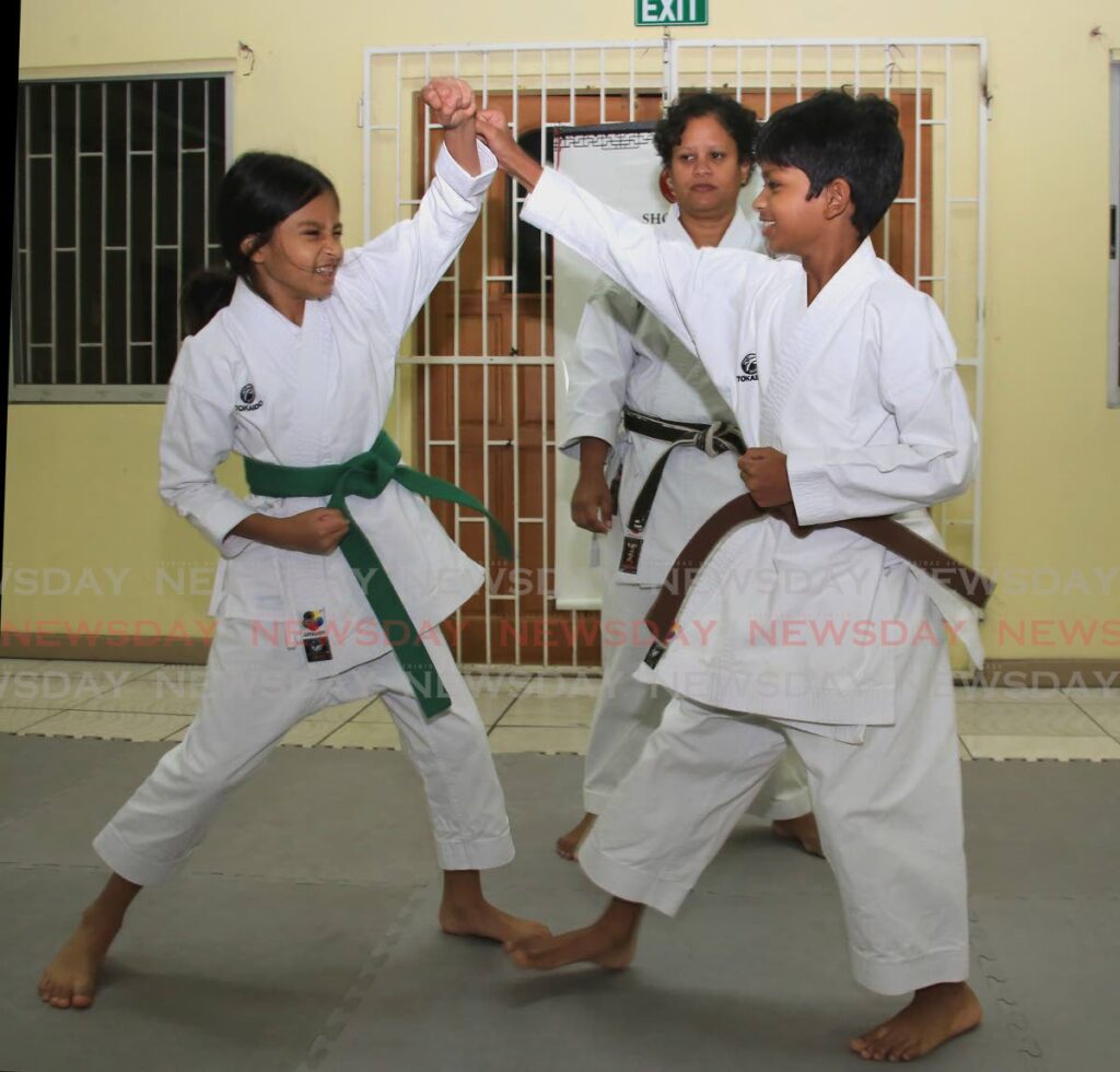 Sibling Zacckarie and Isabella Rampersad spar with each other at the Kuro Obi Shotokan Karate Club, St Augustine South Community Centre, Freedom Street, St Augustine. - ROGER JACOB