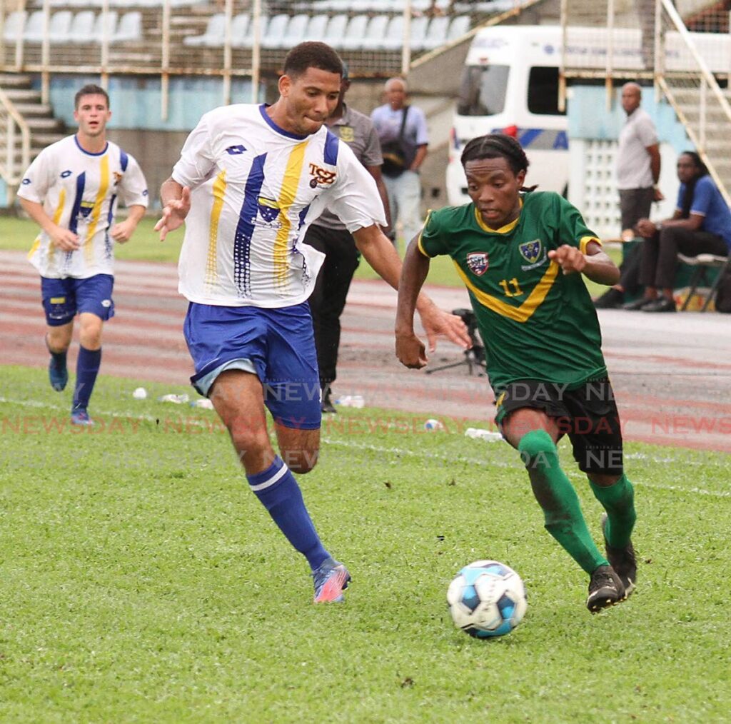 In this October 26 photo, St Benedict’s College player Jeremiah Niles (R) runs with the ball during the SSFL Premiership division final, at the Ato Boldon Stadium, Couva.  - Marvin Hamilton