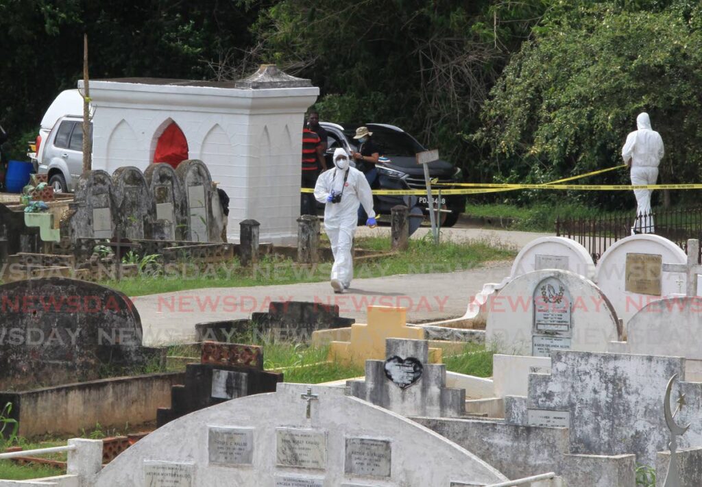 Investigators at the scene where brothers Elvis Hernandez and Nirmal Rambaran were shot dead at the Tunapuna public cemetery on October 29. - ROGER JACOB