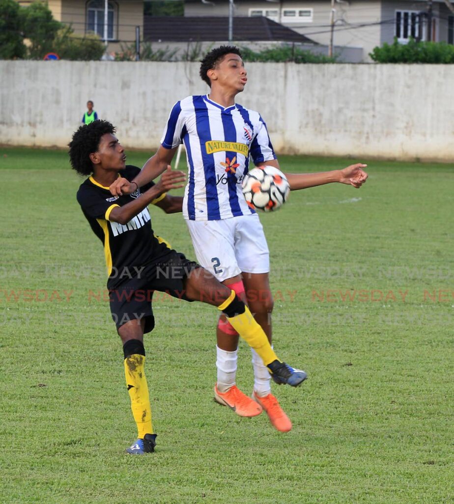 Nicholai Manswell of St Mary’s (right) tries to control the ball despite the challenge of Miracle Ministries’ Jordan Thorne, during the teams’ match in the Secondary Schools Football League Big 5 Championship competition, on Saturday, at the St Mary’s Ground, St Clair. Photo by Roger Jacob