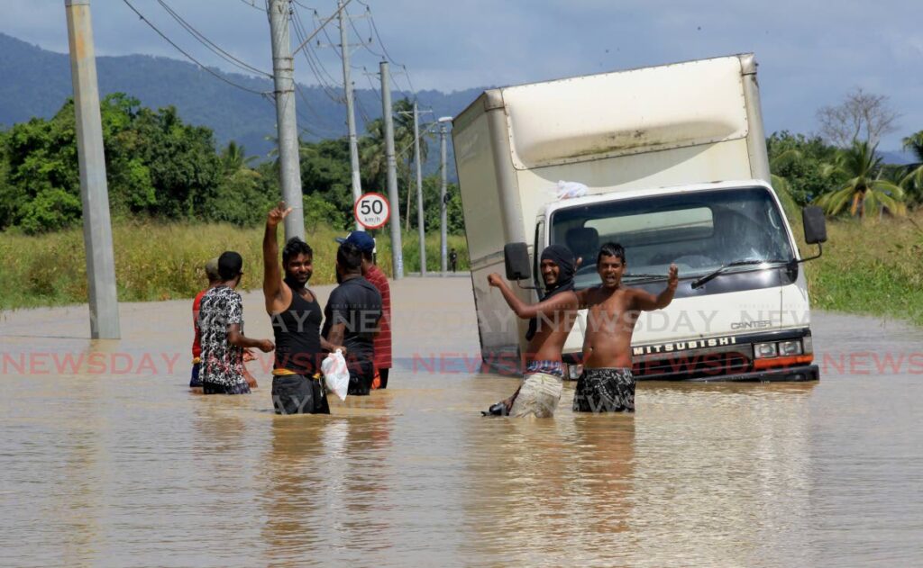 A truck had to be abandoned on Tantrill Road, Pasea South, Tunapuna after it stalled in floodwaters on Monday. Photo by Roger Jacob