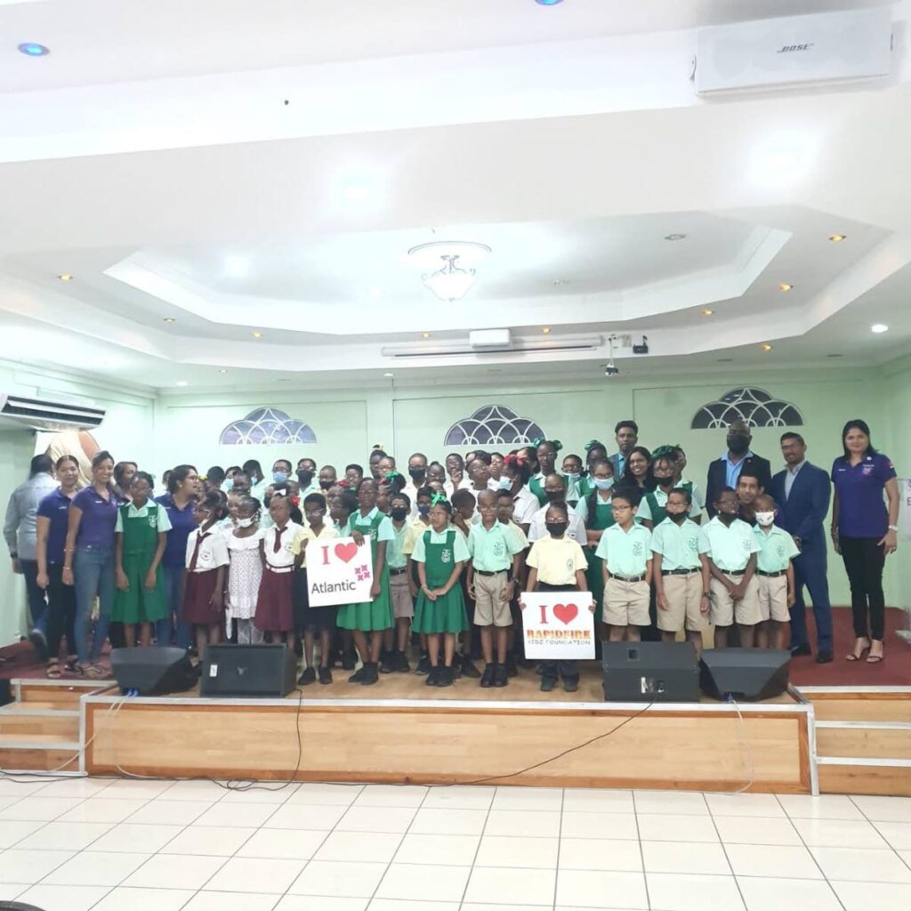 Some of the 80 students from the Point Fortin, Fanny Village, Salazar Trace and Cap de Ville government schools who received eyeglasses from the Rapidfire Kidz Foundation, in collaboration with Atlantic, in Point Fortin on Sunday. - 