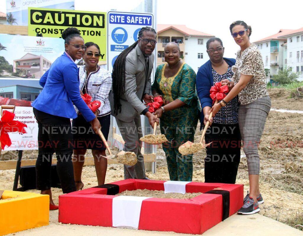 From left: Udecott CEO Tamica Charles-Phillips, HDC managing director Jayselle McFarlene, Minister in the Housing Ministry Adrian Leonce, Minister of Housing Camille Robinson-Regis, a Ministry of Community Development official and St Augustine MP Khadijah Ameen turn the sod at the site of the Oropune Commercial Centre and Community Centre, Orupune Gardens on Tuesday. - AYANNA KINSALE