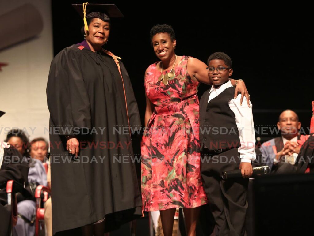 Chancellor of University of Trinidad and Tobago  (UTT) President Paula-Mae Weekes, left,  with Melissa Lynch-Waithe and Jordan Waithe, the widow and son of the late Desmond Waithe, receive his posthumously awarded honorary degree of letters which at  the university's  graduation ceremony at the National Academy for the Performing Arts in Port of Spain, Tuesday. - SUREASH CHOLAI