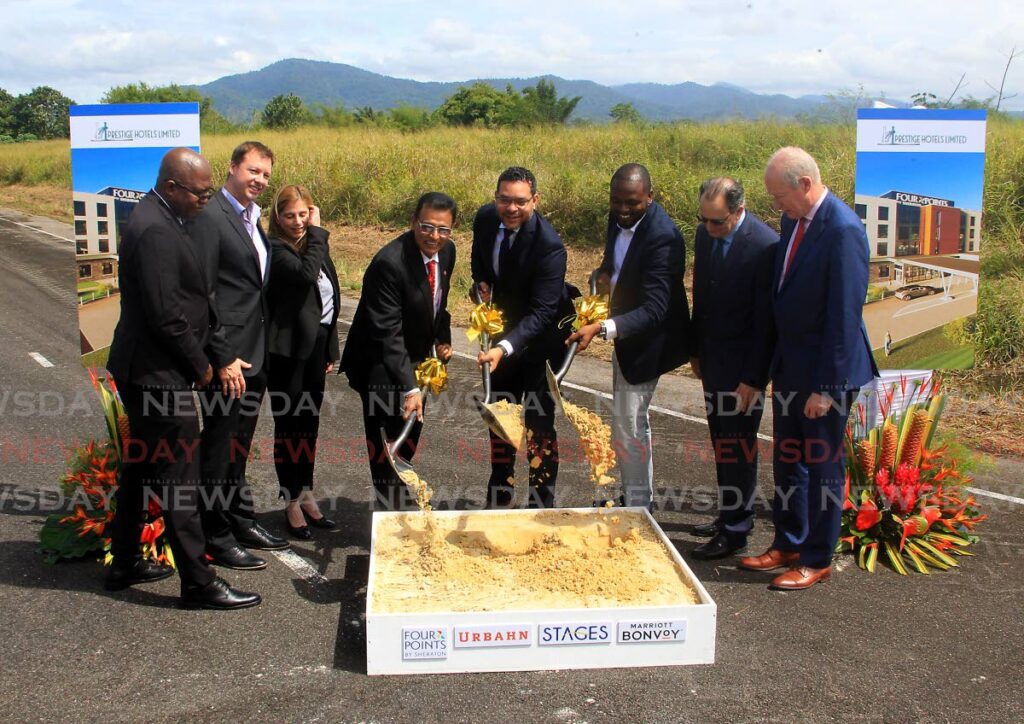 Hayden Newton, from left, Christopher Alcazar, Ursula Gutierrez, Rohan Sinanan, Randall Mitchell, Tamarco Edwards, Natale Barranco and Jan van der Vaart at the sod-turning ceremony for a Four Points by Sheraton hotel at the North Aviation Business Park, Piarco, on Wednesday. - ROGER JACOB