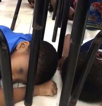 EVASIVE ACTION: This screen grab from a video shared widely on social media on Tuesday, shows students of the Rose Hill RC Primary School on the floor in their classroom after being told by their teacher to duck when rapid gunfire broke out in the surrounding area outside the school on Monday.  