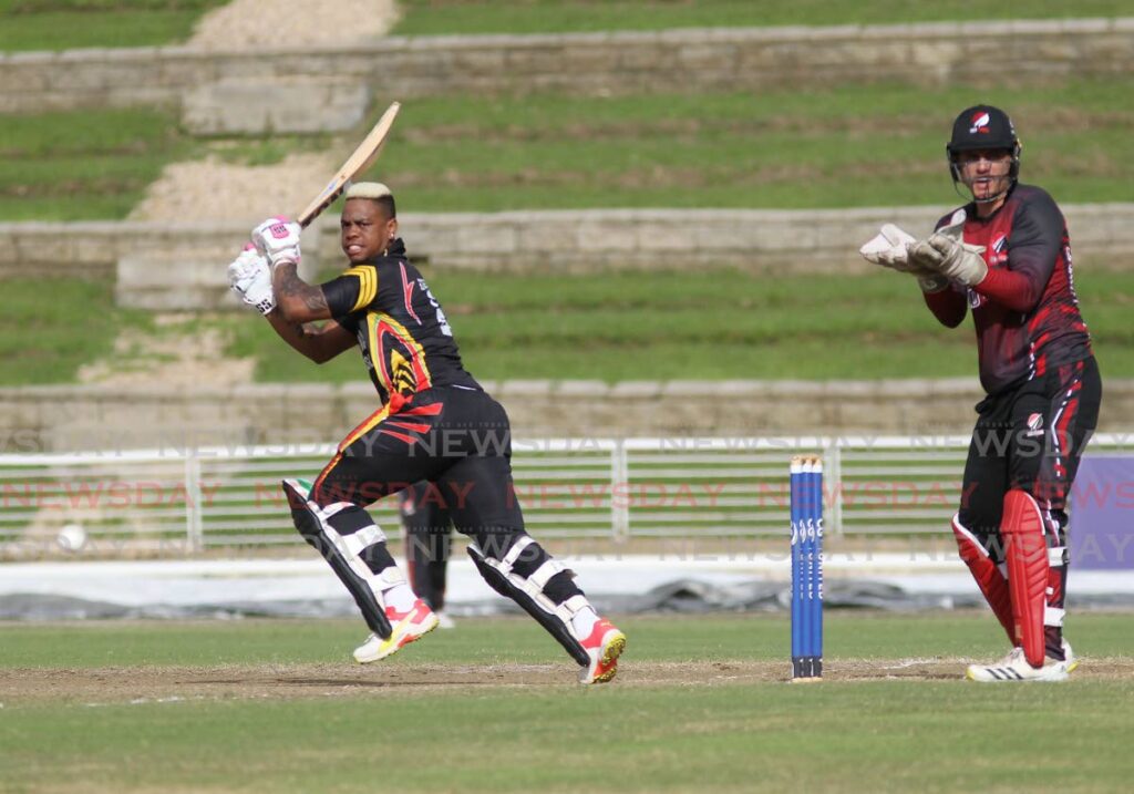 Guyana Harpy Eagles’ Shimron Hetmyer plays a shot during the CG United Syper50 Cup match on Wednesday against TT Red Force at the Brian Lara Cricket Academy, Tarouba. At right, TT Red Force wicketkeeper Joshua da Silva looks on.  Photo by Lincoln Holder