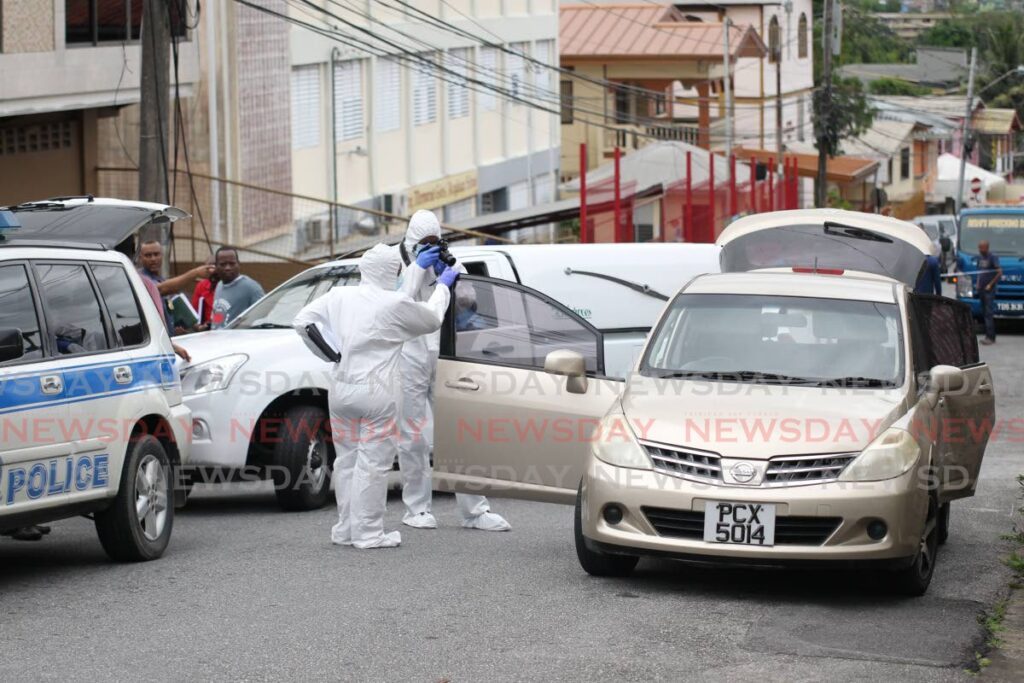 In this November file photo, crime scene investigators  process the car driven by Sahmzard Mohammed  who shot his wife  Keisha Bostic on Drayton street San Fernando in a murder-suicide.   Photo by Lincoln Holder