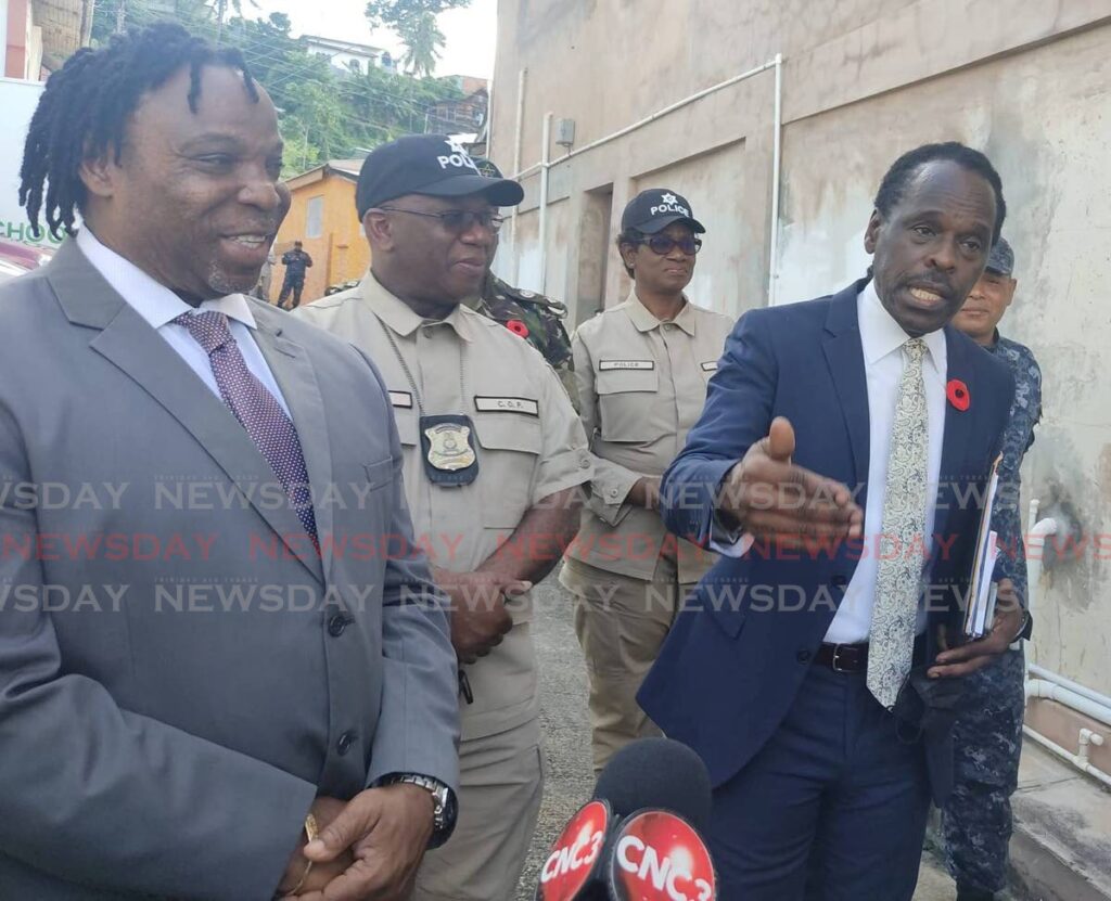 National Security Minister Fitzgerald Hinds, right gestures while speaking with reporters at the Rose Hill RC Primary School, Le Coulee Street, east Port of Spain, on Monday morning. 
Port of Spain South MP Keith Scotland and acting Police Commissioner McDonald Jacob look on.  - Photo by Shane Superville