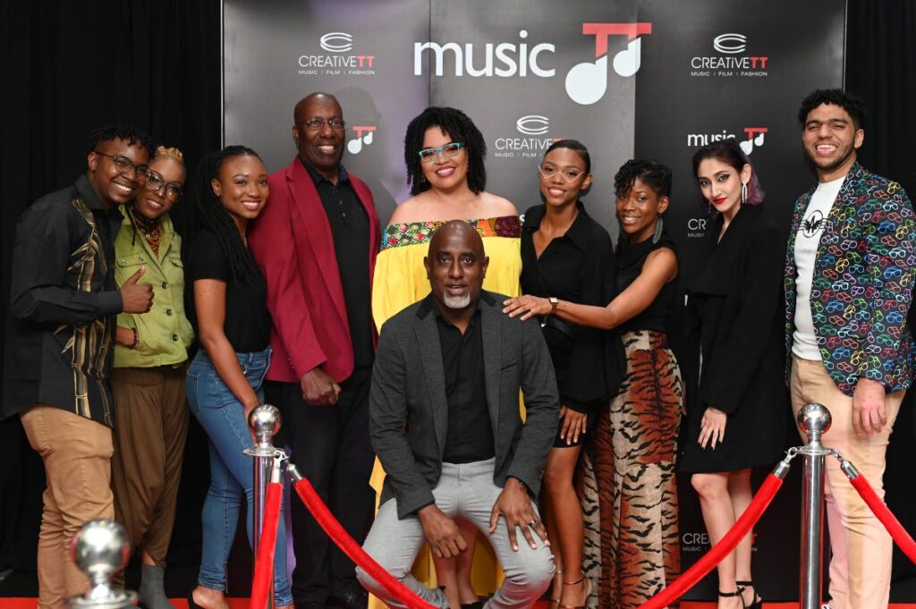 MusicTT chairman John Arnold, fourth from left, and general manager Melissa Jimenez, centre, with artistes at the red-carpet premiere of Project Spotlight III album at IMAX. 