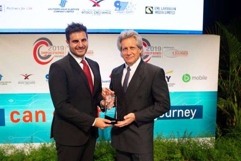 Ian Galt, TSTT’s general manager, enterprise services, presents Oliver Sabga, CEO of Term Finance with the 2019 bmobile Business Technology Award at the TT Chamber of Industry Champions of Business ceremony. Term Finance will present the award to the 2022 winner on November 24. Photo courtesy TSTT. - 