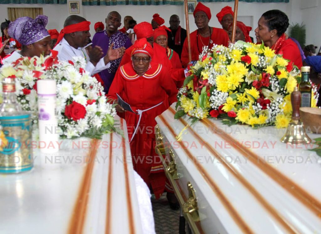 Relatives and friends of Korey Clarke and Samantha Patrick dance and sing at their funeral at the Mt St Jude Spiritual Baptist Church, Aboud Circular, St James.  - AYANNA KINSALE