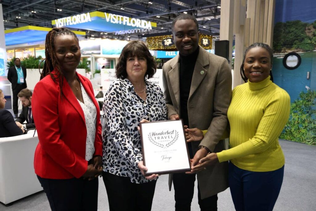 THA Chief Secretary Farley Augustine, second from right, collects the Wanderlust Travel Magazine's silver award for Most Desirable Island from Wanderlust Travel editor-in-chief and CEO George Kipouros, second from left, at the conclusion of World Travel Market in London, England, Wednesday. Also present were Tourism Secretary Tashia Burris, right, and Tobago Tourism Agency Ltd chairman Alicia Edwards.  Photo courtesy THA