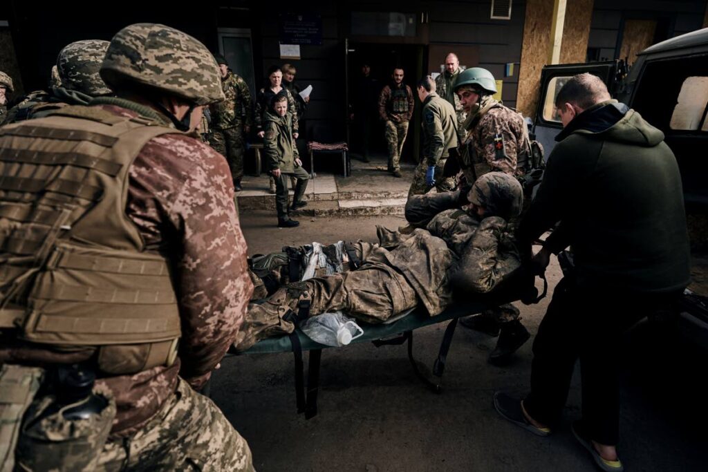 Ukrainian soldiers carry a wounded soldier into a hospital in Bakhmut, Donetsk region, Ukraine, on November 9.  - AP PHOTO
