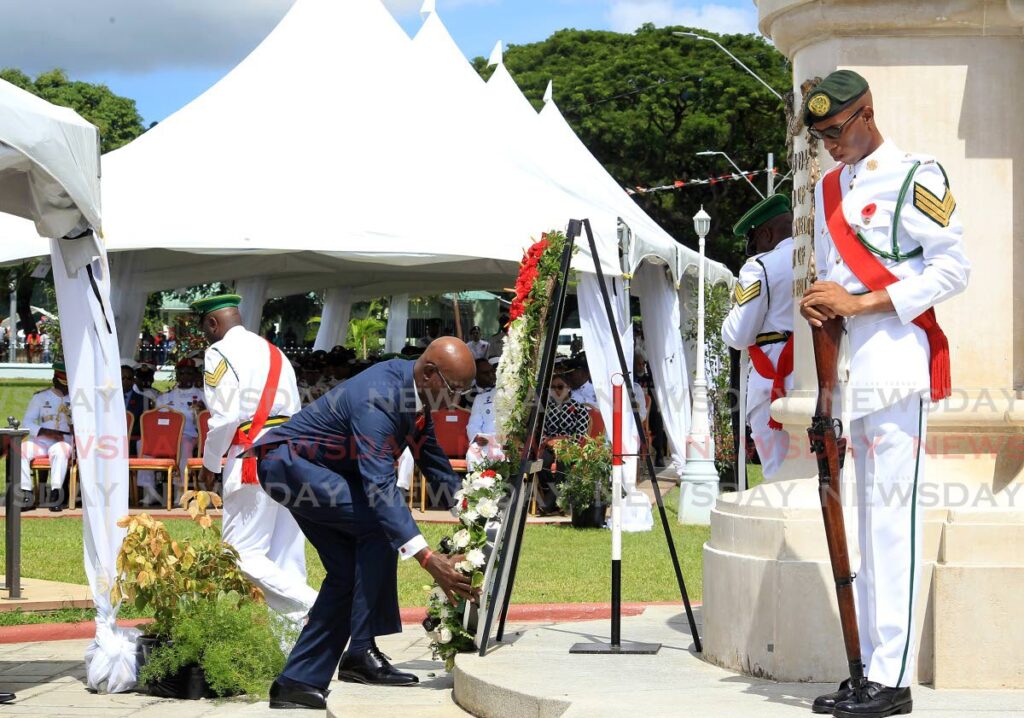 Prime Minister Keith Rowley lays a wreath at the cenotaph in Memorial Park.  - Photo by Roger Jacob