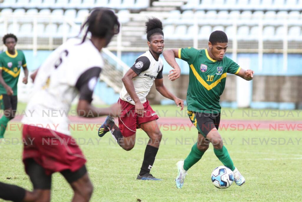A St Benedict’s players (R) controls the ball against Moruga Secondary during the Coca-Cola South Zone Intercol semi-final match, on Wednesday, at the Ato Boldon Stadium, Couva. Photo by Marvin Hamilton