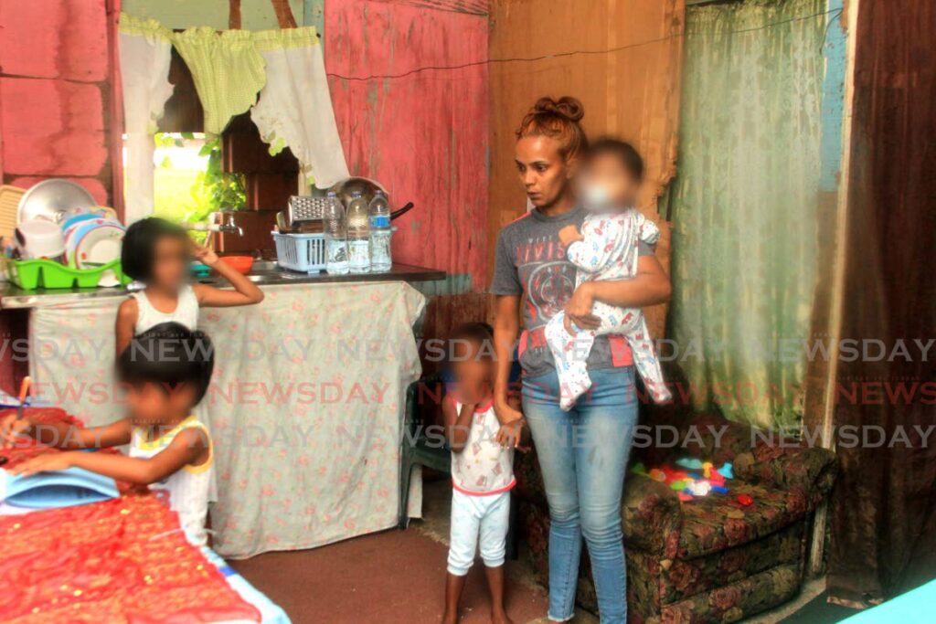 PLEASE HELP US: Samantha Persad with four of her five children at her Railway Road, Longdenville, Chaguanas home. - Photo by Roger Jacob