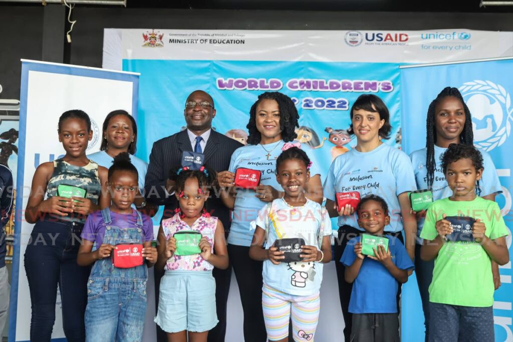 From left, Alana Shura USAID covid19 response coordinator, US Embassy Chargé d'Affaires Shante Moore, Celine Julia Felix Social Policy manager Unicef and Rhea Mars Chester communications officer Unicef pose with some children at the health fair at the Queen's Park Savannah, Port of Spain on Saturday. - PHOTO BY JEFF K MAYERS