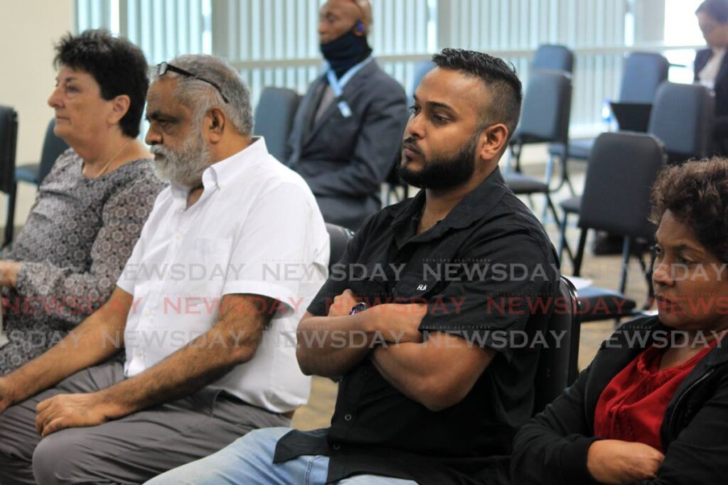 Relatives of the divers who died in the Paria tragedy listen intently to the proceedings of the commission of enquiry at Tower D, Waterfront, Port of Spain on Monday. - ROGER JACOB