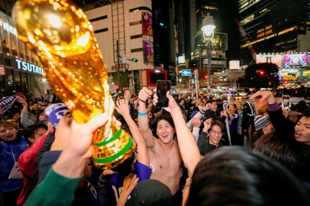 Fans celebrate at Shibuya crossing in Tokyo, as Japan's national football team won against Germany in the World Cup in Qatar, early Thursday. - AP Photo