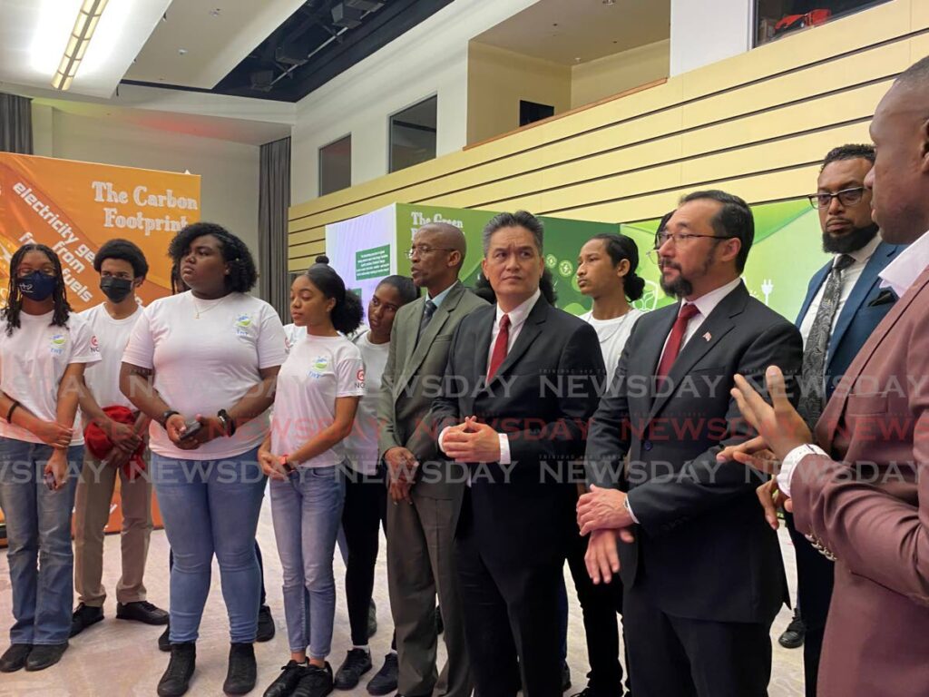 Adrian Thomas, founder of Renew Caribe (Far right) discusses renewable energy with Energy Minister Stuart Young, NGC chairman Mark Loquan and a group of students at the Hyatt Regency, Port of Spain on Wednesday at the launch of Re-Energize TnT.  - Photo by Narissa Fraser