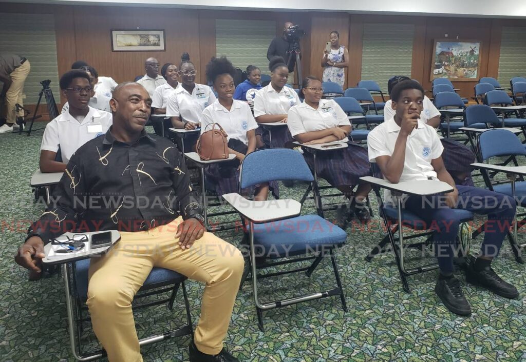 THA Assistant Secretary of Community Development, Youth Development and Sport, Wane Clarke, sits among students during the launch of the WOS Pass it on youth leadership programme at the Shaw Park Cultural Complex on Wednesday - Photo by Kinnesha George-Harry 