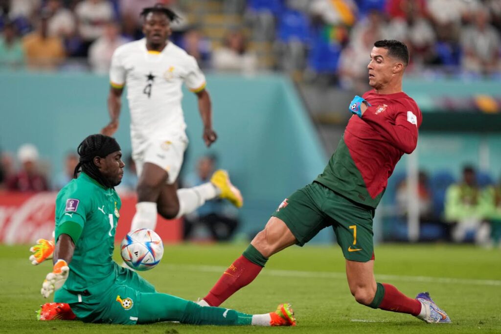 Ghana's goalkeeper Lawrence Ati-Zigi, left, makes a save against Portugal's Cristiano Ronaldo during the World Cup group H  match, at the Stadium 974 in Doha, Qatar, on Thursday. - AP PHOTO