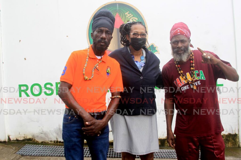 Rose Hill RC Primary School Principal Sharlene Quinima with Jamaican reggae artistes Sizzla, left, and Capleton, during their tour of the school on Thursday. PHOTO BY ROGER JACOB - 