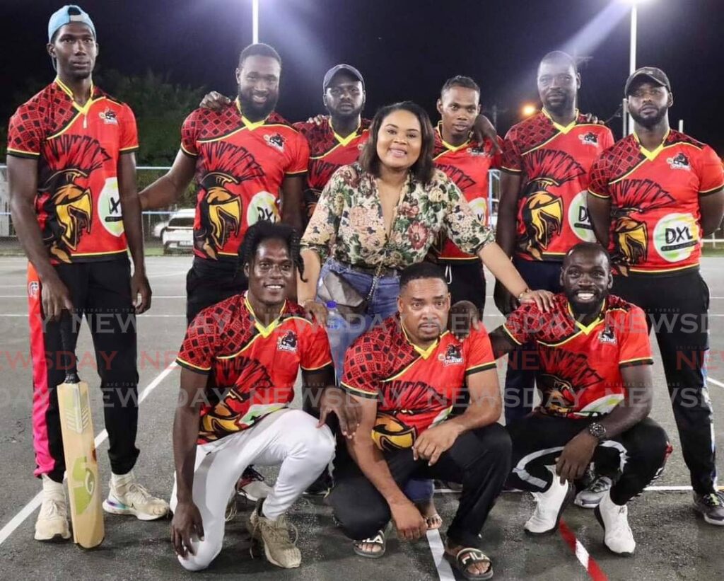 Members of the DXL Spartans and Minister of Sport and Community Development Shamfa Cudjoe celebrate the team's win in the final of the Canaan/Bon Accord Night Wind-ball Cricket league, against East/West Outlawz, on Sunday. - 