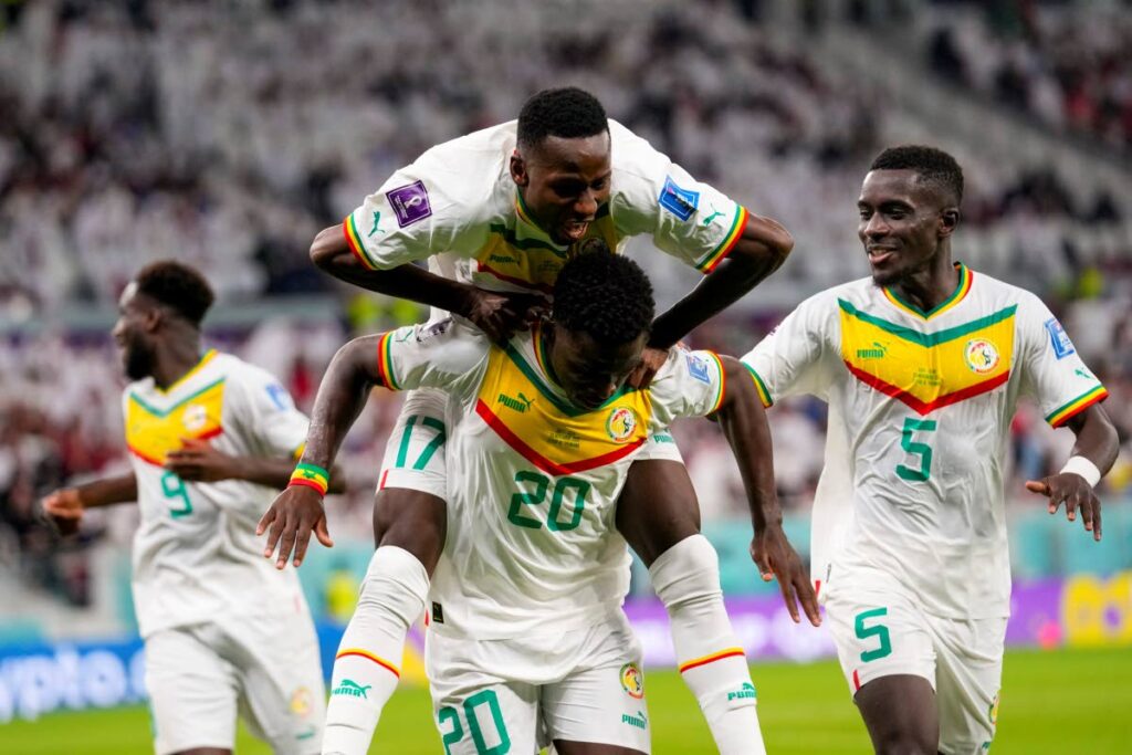 Senegal players celebrate a goal against Qatar in a World Cup group A match at the Al Thumama Stadium in Doha, Qatar, Friday. - AP