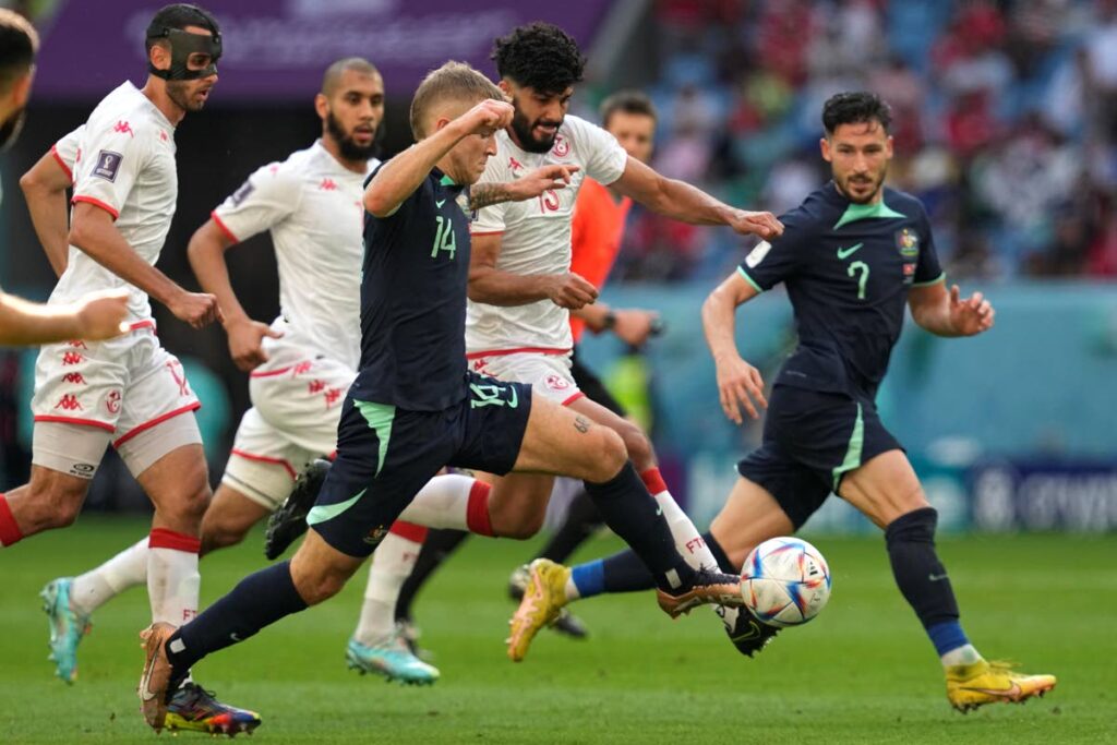Australia's Riley McGree, left, and Tunisia's Ferjani Sassi vie for the ball during the World Cup group D match at the Al Janoub Stadium in Al Wakrah, Qatar, on Saturday. (AP Photo) 