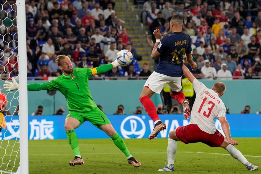 France's Kylian Mbappe scores his side's second goal against Denmark during a World Cup group D match at the Stadium 974 in Doha, Qatar, on Saturday. (AP Photo) 