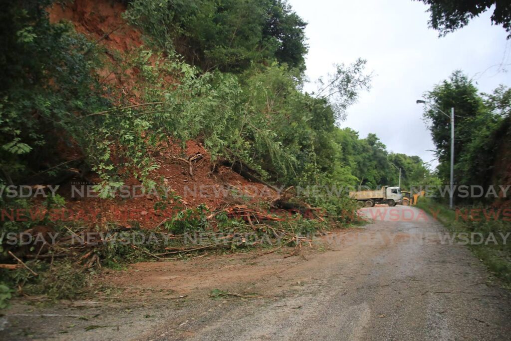 Two major landslides and smaller landslips led to the closure of the Lady Young Road in Morvant near the Hilton hotel to allow workers to clear the debris. - Photo by Sureash Cholai