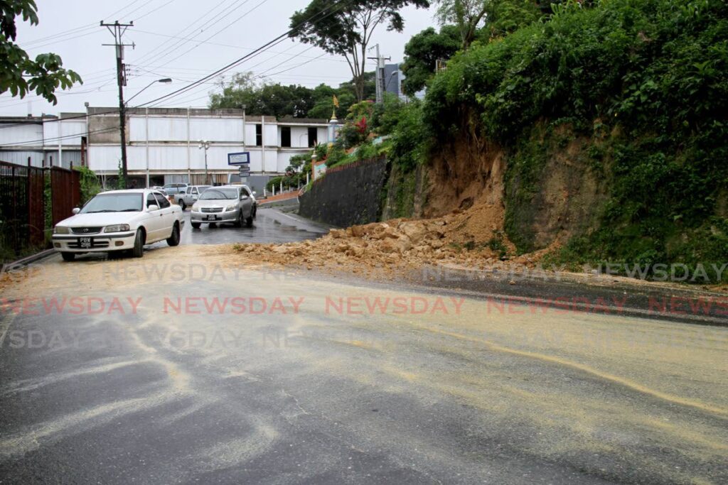 Drivers make their way past a landslide on Pointe-a-Pierre Road, San Fernando, on Sunday. - AYANNA KINSALE