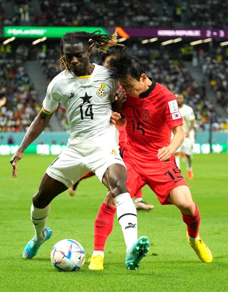 Ghana's Gideon Mensah (L) battles for the ball with South Korea's Kim Moon-hwan during the World Cup group H match, at the Education City Stadium in Al Rayyan, Qatar, on Monday. (AP Photo) - 