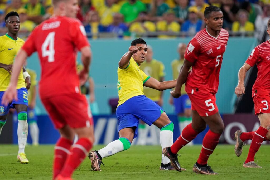Brazil's Casemiro (C) looks at the ball after shooting to score the opening goal during the World Cup group G match, at the Stadium 974 in Doha, Qatar, on Monday. Casemiro scored once in Brazil's 1-0 victory. (AP Photo) - 