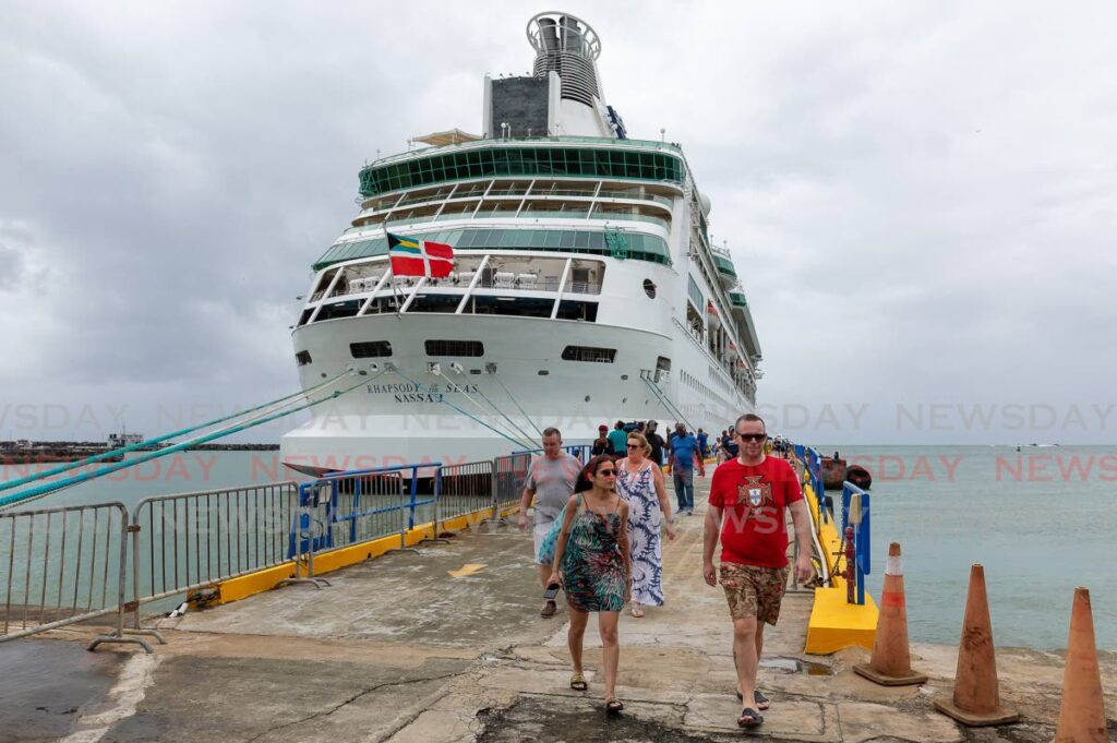 Tourists disembark the Rhapsody of the Seas Nassau cruise line at the Scarborough Port on Monday. - David Reid