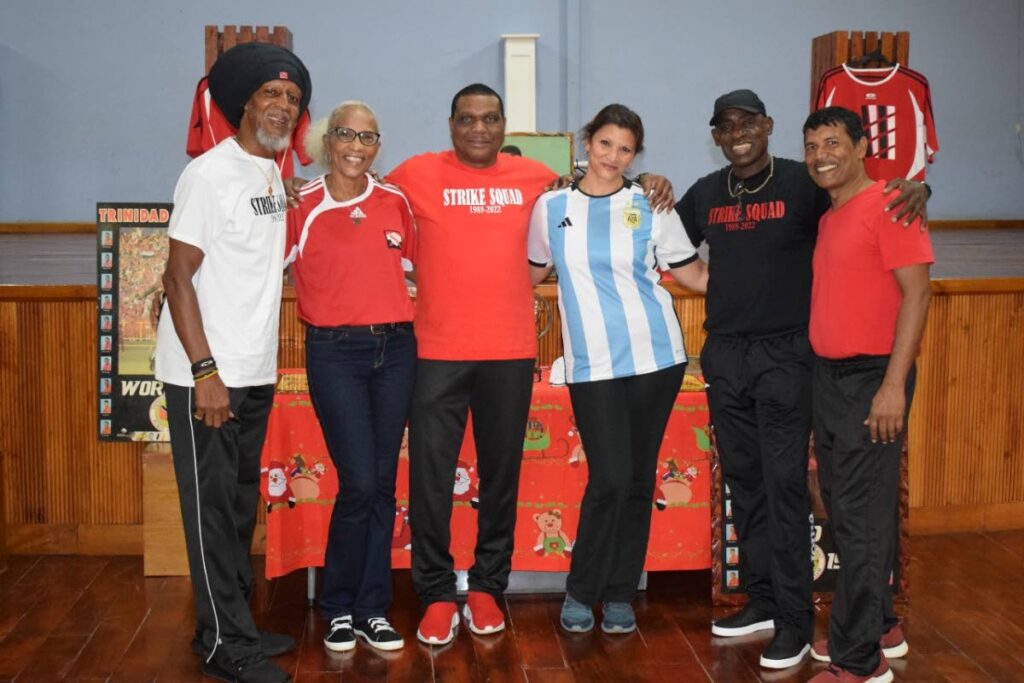 Strike Squad players Brian Williams, left, Kerry Jamerson, third from left, and Clayton Morris, second from right, with staff of the St Peters Private Primary School in Pointe-a-Pierre.  - 