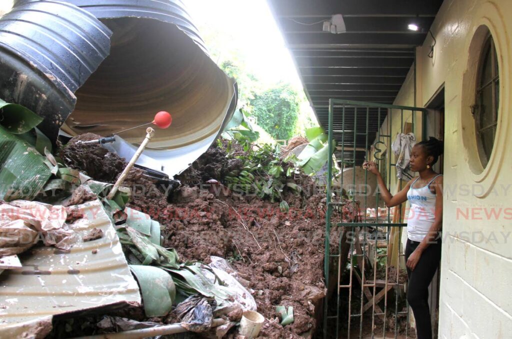 Kelia Logan is greeted by a backyard full of earth and rubble caused by a landslide that crumbled a retaining wall at the back of her home on John Street, St James, on Tuesday. Luckily no one was seriously hurt during the incident.
See page 11. - AYANNA KINSALE