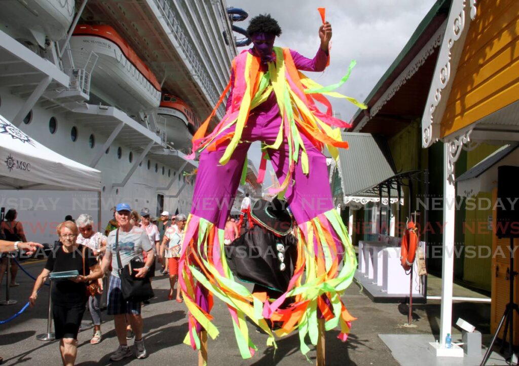 A Moko Jumbie entertains tourists who came off the MSC Seashore cruiseship which docked in Port of Spain on Wednesday. Photo by Ayanna Kinsale