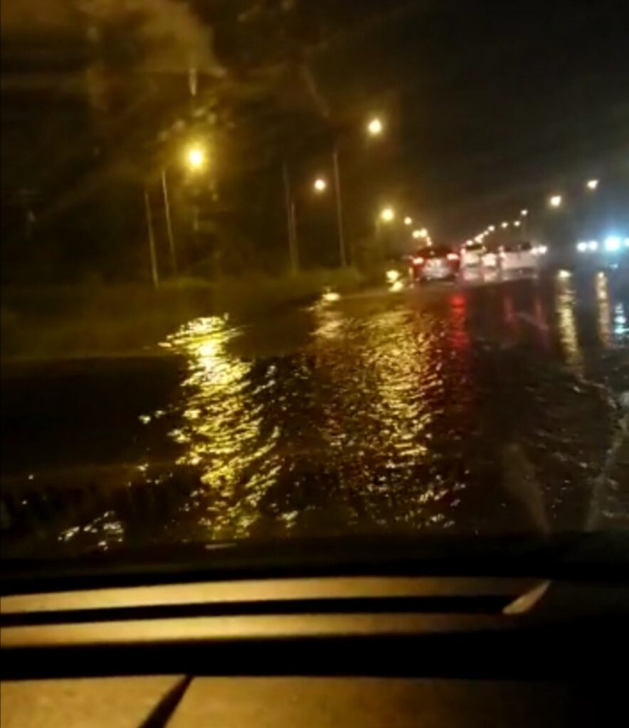 Screengrab from a video of a motorist driving through floodwater on the southbound lane of the Uriah Butler Highway, owing to overflow from the Caroni River. Like many motorists on Monday, the driver complained of being stuck in traffic for surplus three hours. 